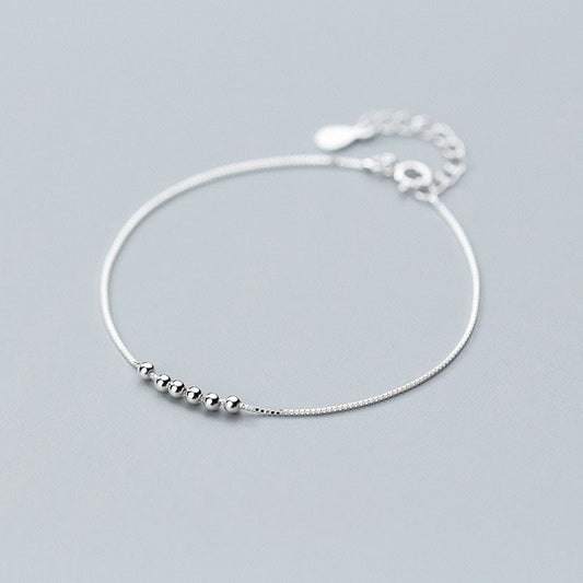 Bracelet chaîne de perles à breloques simples