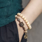 Bracelet tibétain en perles d’os de yak à deux rangées avec charme en cuivre martelé