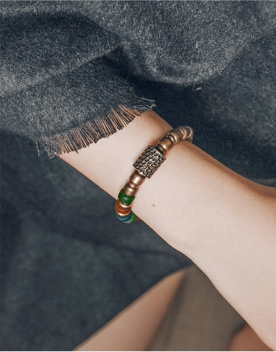 Bracelet de perles de verre colorées avec breloque en cuivre martelé