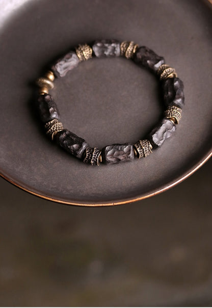 Bracelet made of Concave Convex Ebony Wood Bead and Hammered Copper