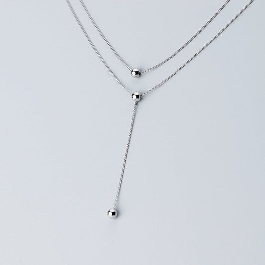 Halskette in Y-Form mit dreilagigen Perlen