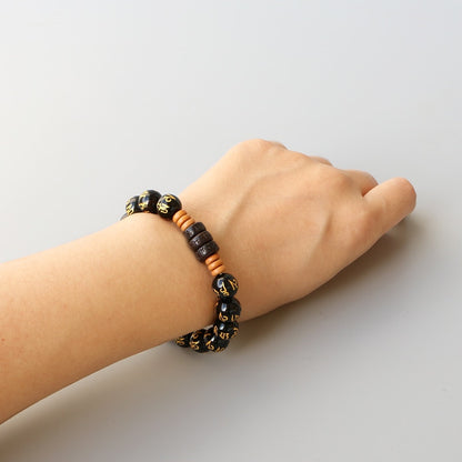 Bracelet extensible « Six vrais mots » plaqué or onyx sculpté