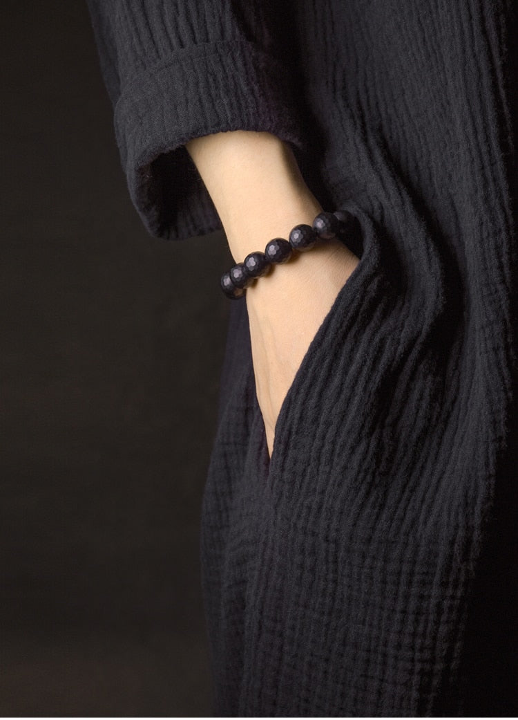 Bracelet de perles d'onyx à facettes avec perle tibétaine anti-mal