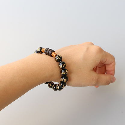 Bracelet extensible « Six vrais mots » plaqué or onyx sculpté