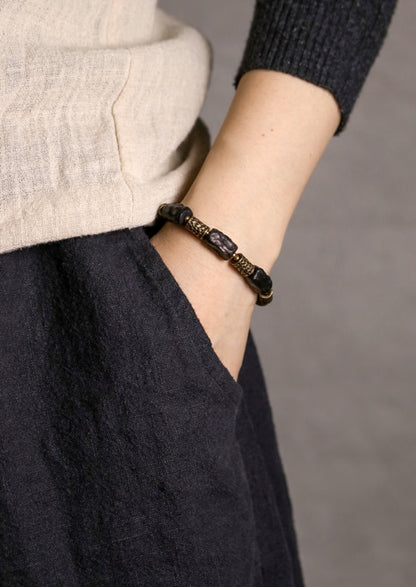 Bracelet made of Concave Convex Ebony Wood Bead and Hammered Copper