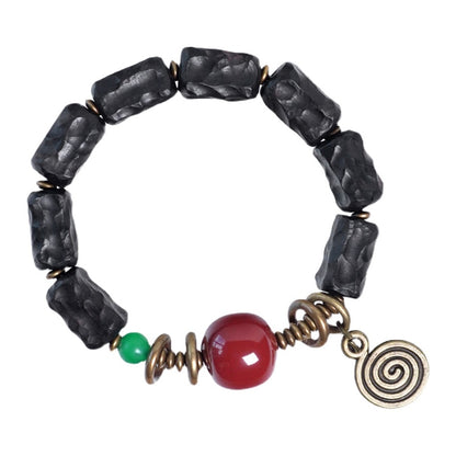 Bracelet de perles d’ébène sculpté, charme d’agate Gobi